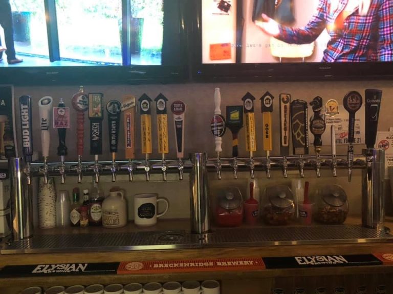 Draft beer handles lined up under flat screen TVs at The Palms Grand Casino in Billings